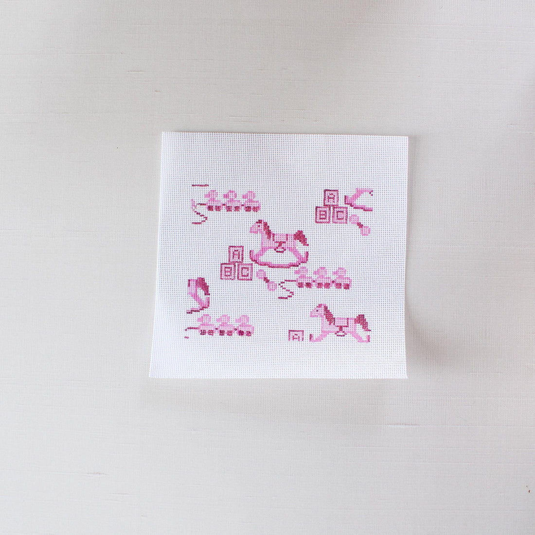 needlepoint canvas hand painted on 13 mesh featuring a nursery themed toile in pink